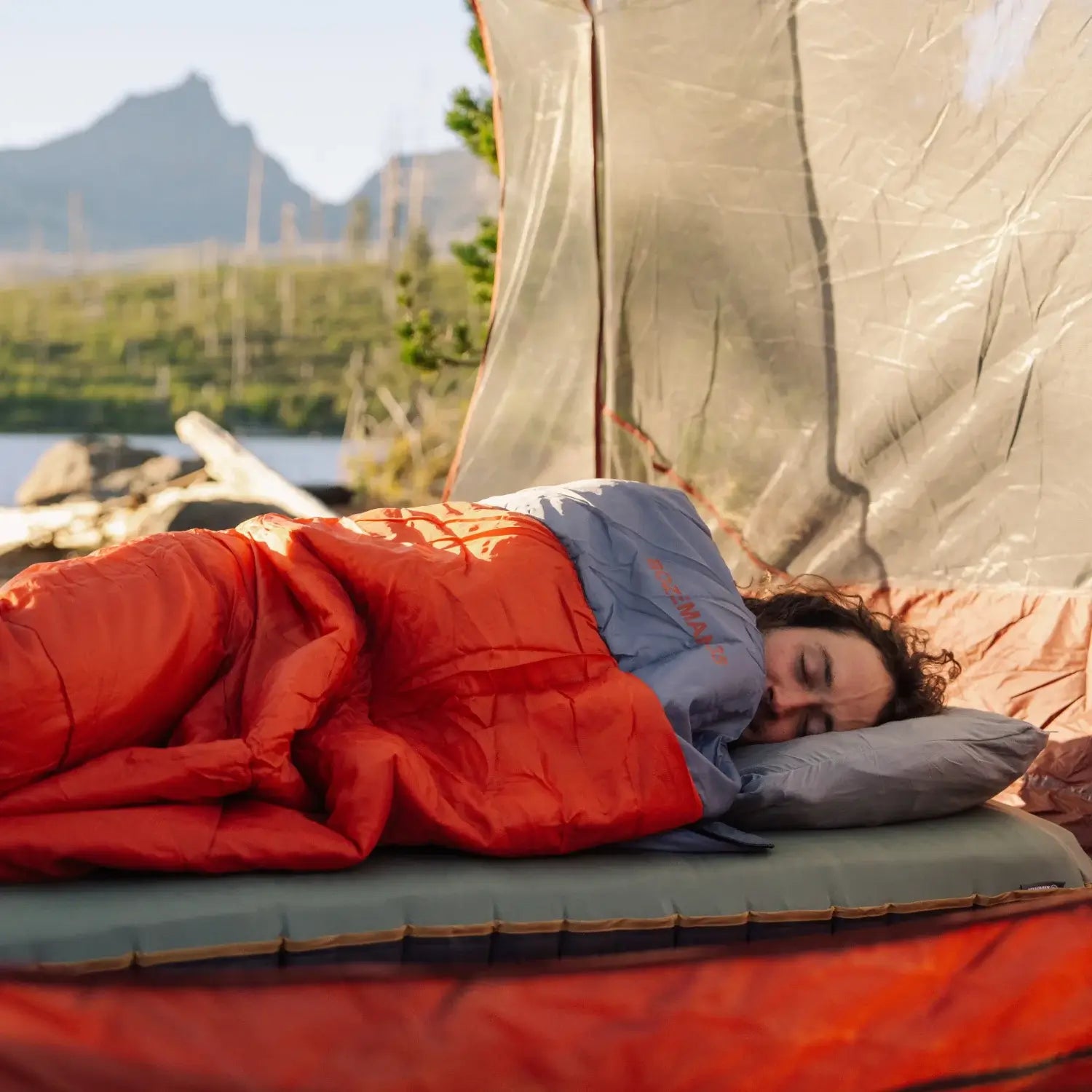 A man sleeping in a sleeping bag.