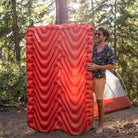 Insulated Double V Sleeping Pad, Orange, Lifestyle Man Standing with Pad