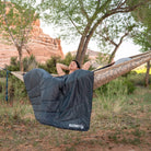 Horizon Travel Blanket, Gray, Lifestyle Woman Sitting on a Hammock with the Blanket