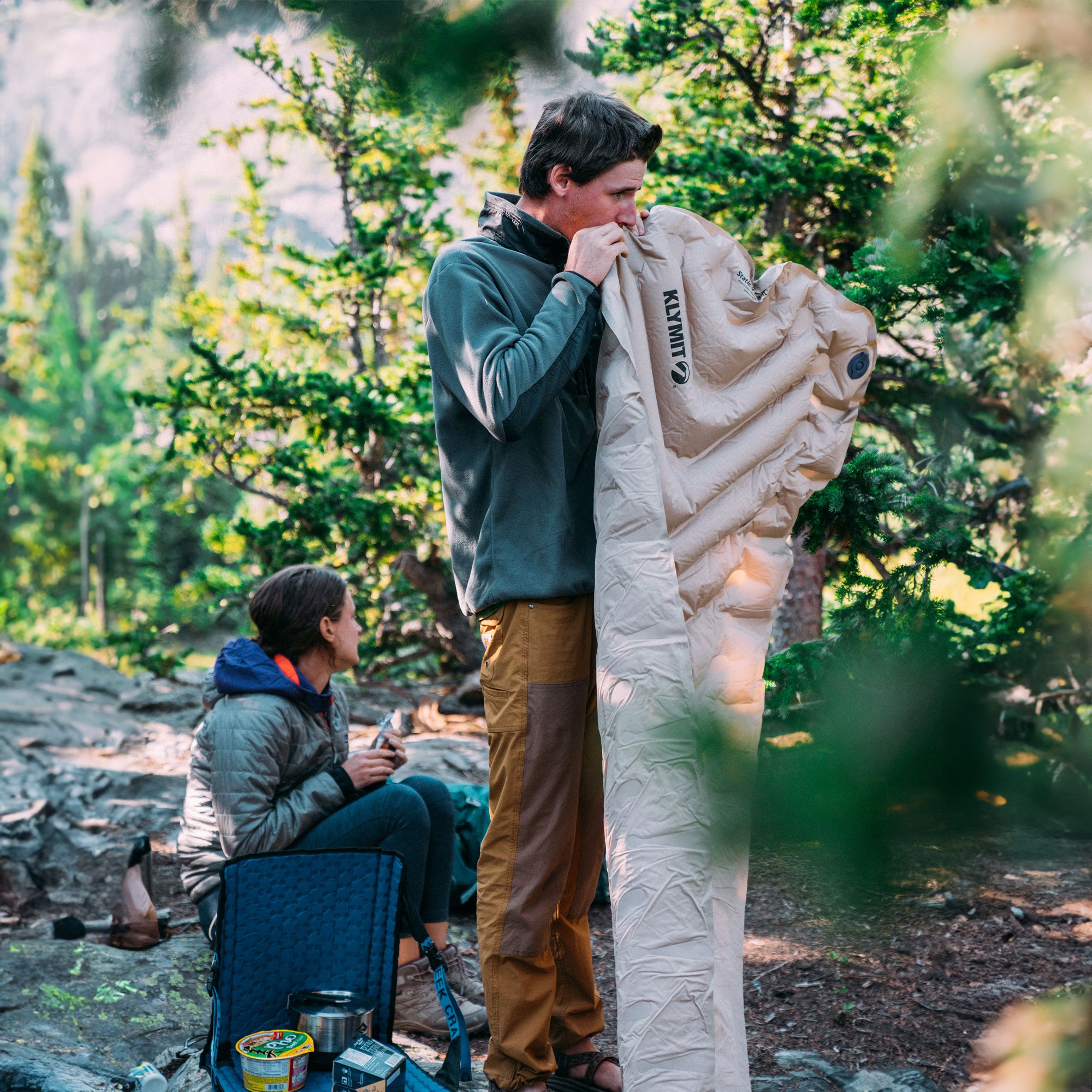 Insulated Static V Luxe SL Sleeping Pad, Recon, Lifestyle Man Inflating the Pad