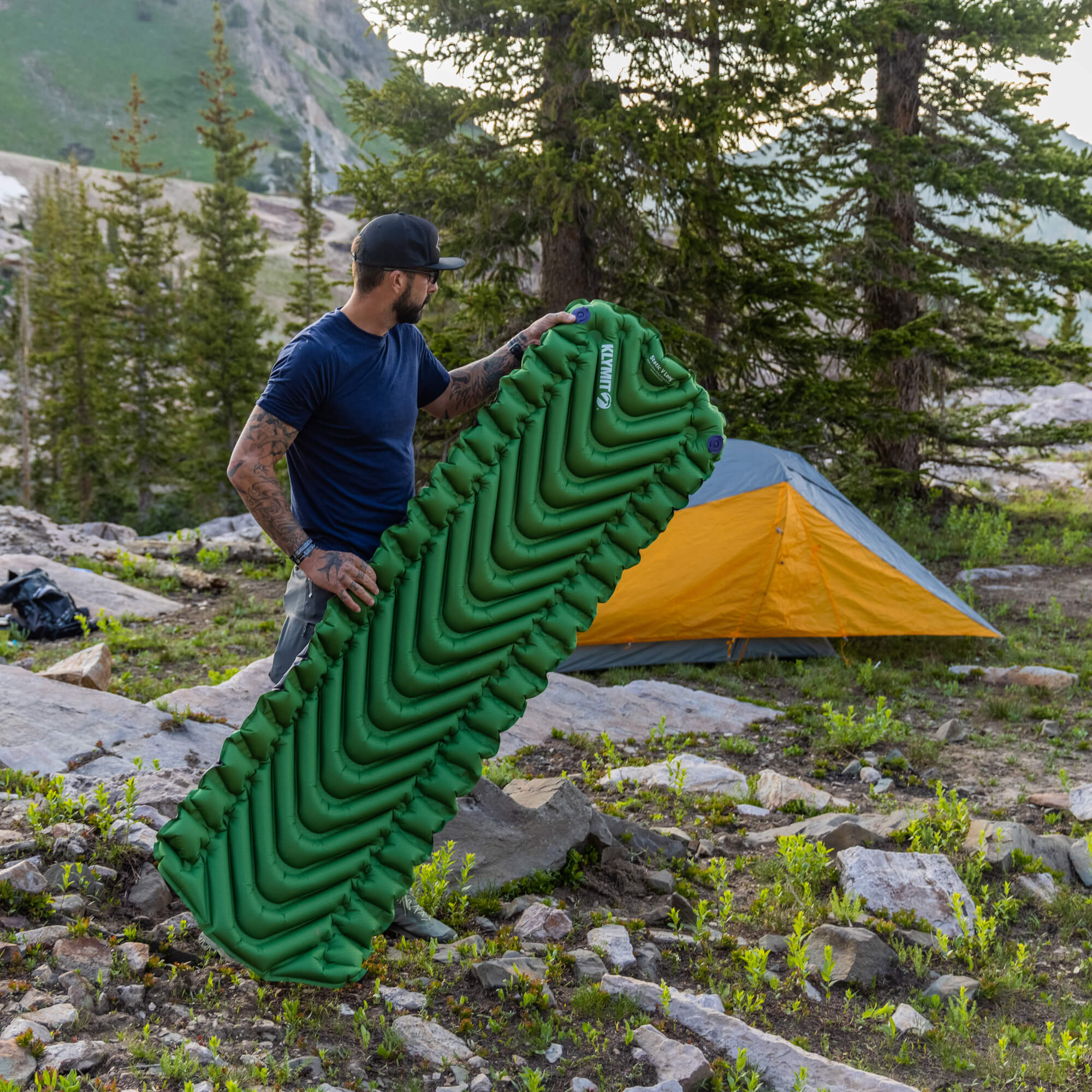 Static V Long Sleeping Pad, Green, Lifestyle Man Holding the Pad