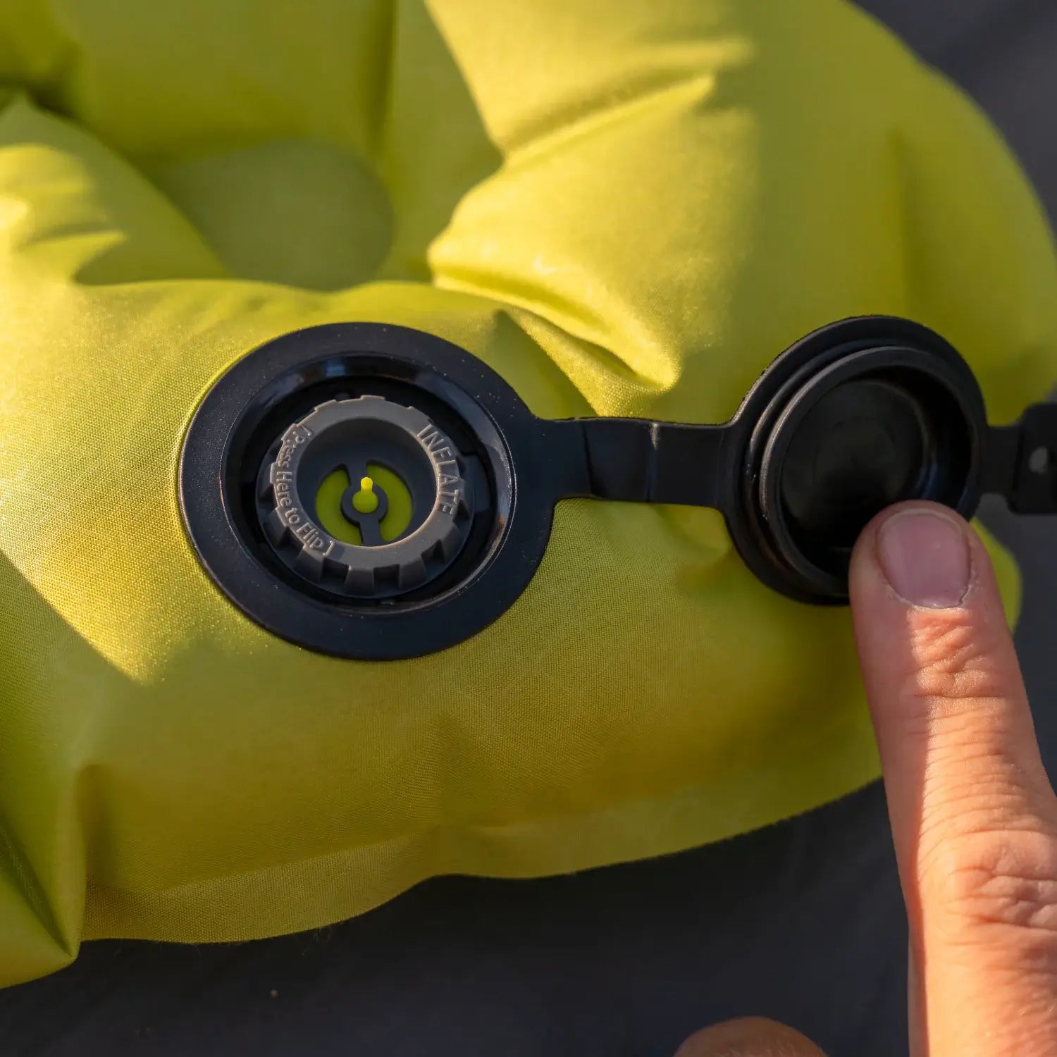 Close-up of the inflate and deflate dual valve system on a chartreuse Klymit Static V Summit sleeping pad.