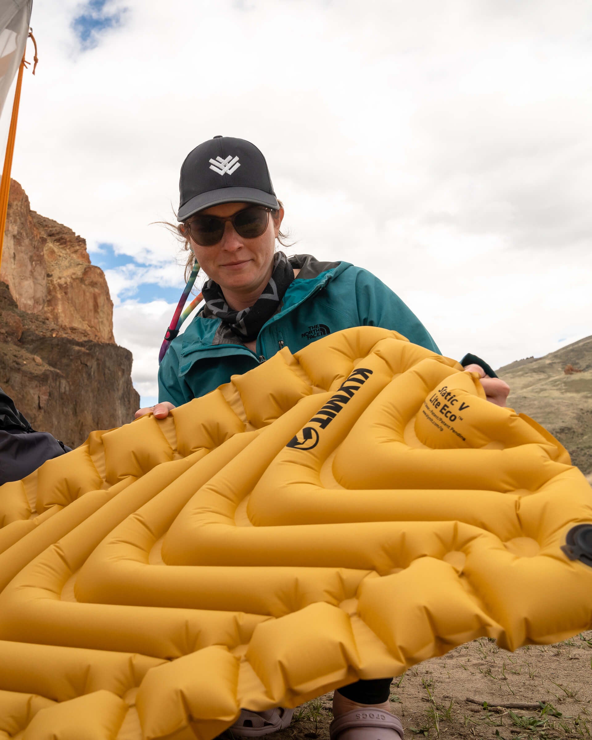 Static V Lite Eco Sleeping Pad, Gold, Lifestyle Woman Holding the Pad