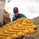 Static V Lite Eco Sleeping Pad, Gold, Lifestyle Woman Holding the Pad
