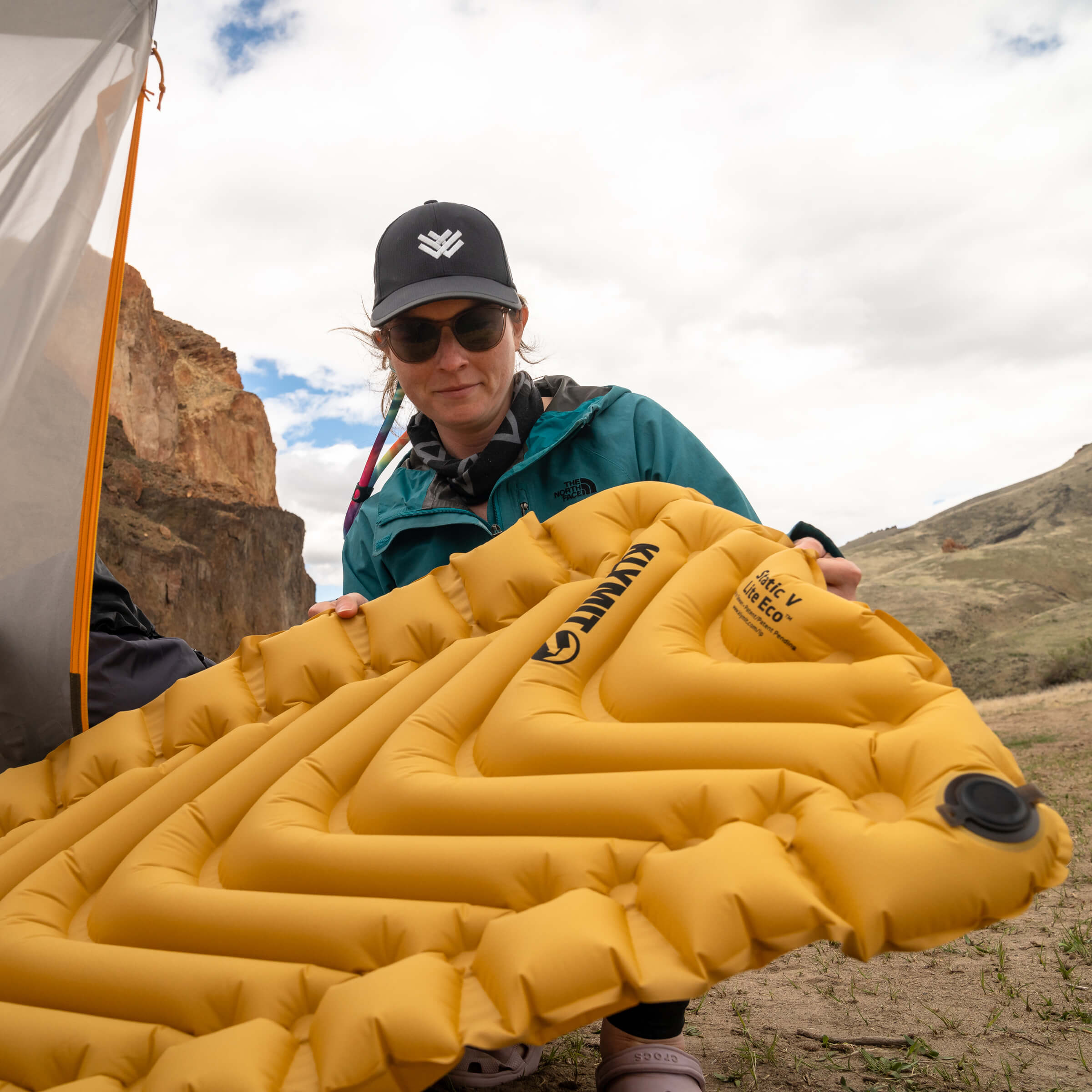 Static V Lite Eco Sleeping Pad, Gold, Lifestyle Woman Holding the Pad