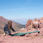 Static V Short Sleeping Bag, Green, Lifestyle Girl Folding the Pad