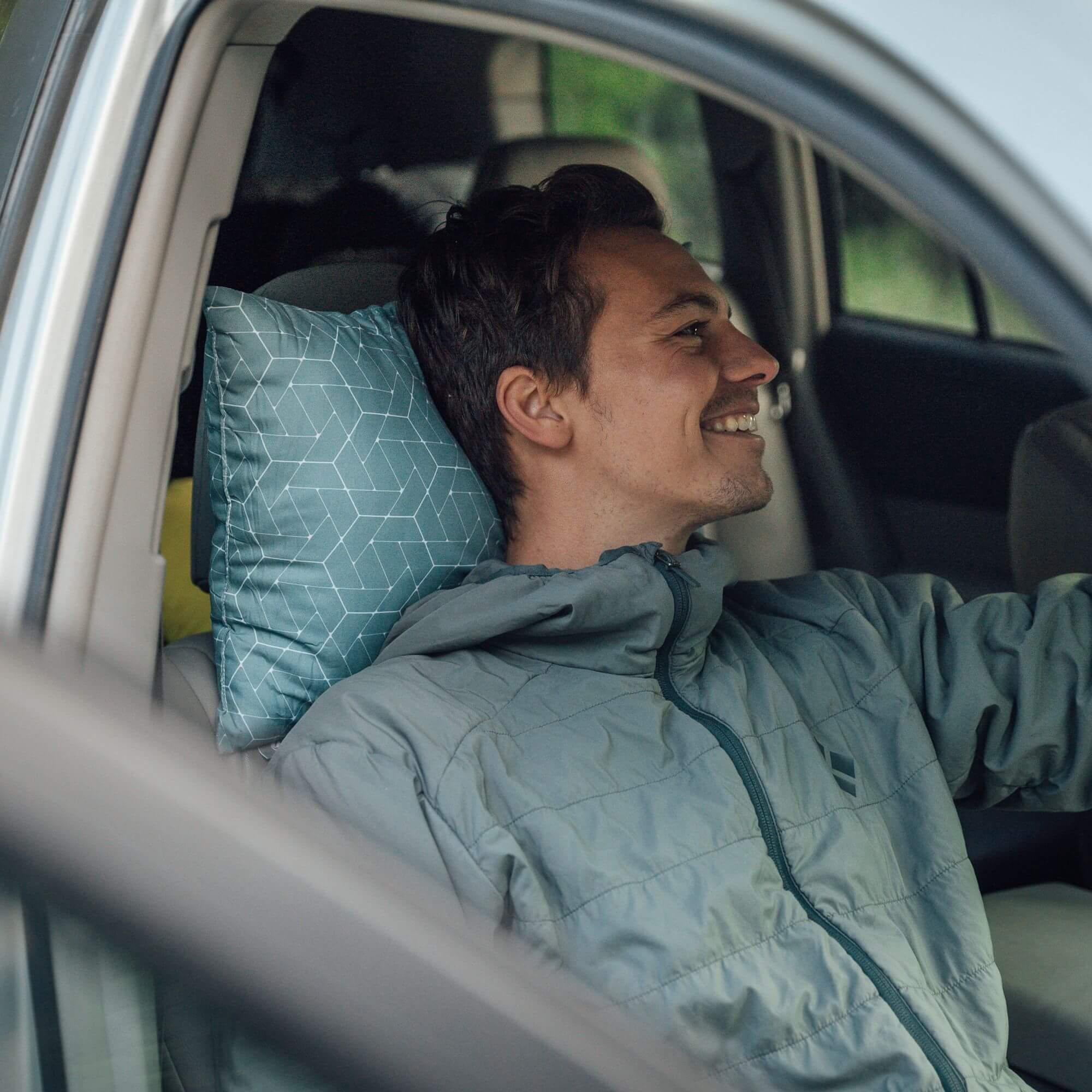 Coast Travel Pillow, Teal, Lifestyle Man Leaning on Pillow in a Car