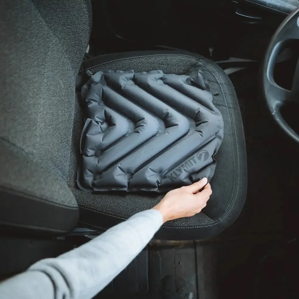 Inflatable V Seat being adjusted by a person inside a vehicle.