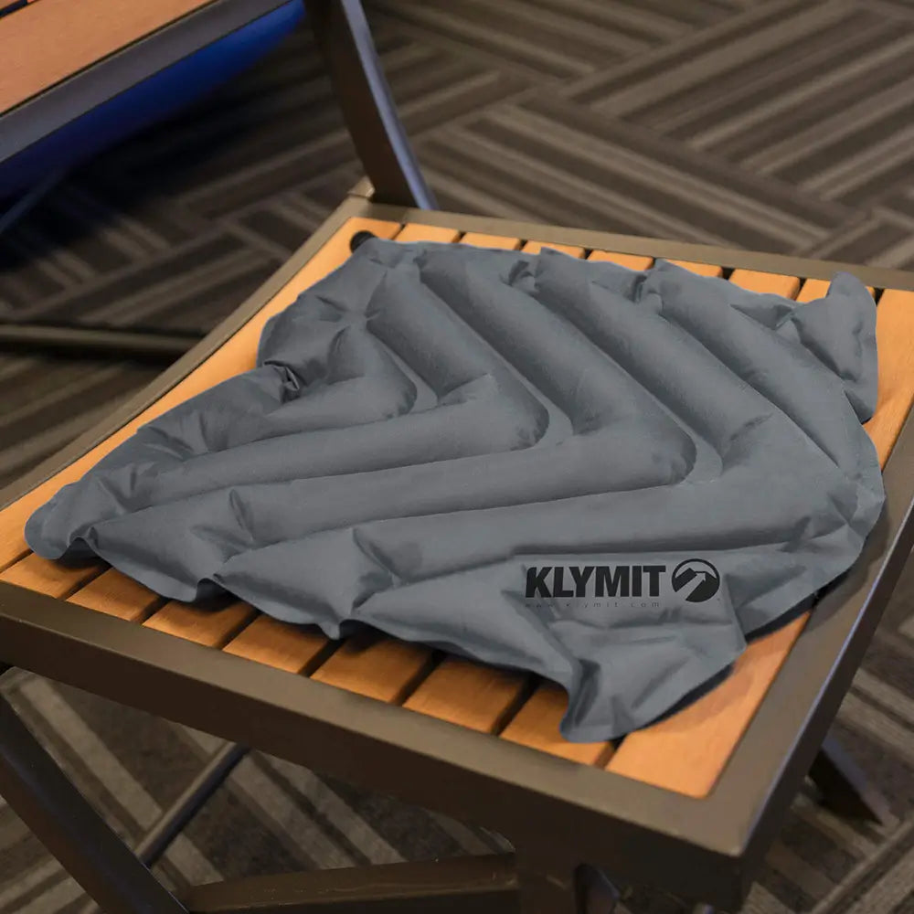 Gray KLYMIT V Seat on a wooden chair