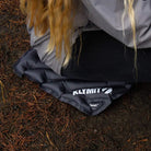 Person using a Klymit V Seat on the ground