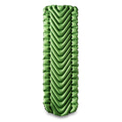A rectangular green inflatable sleeping pad with v shaped pattern shown face on.